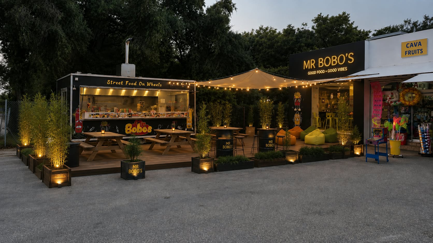 Proposed redesign with a wooden terrace, picnic tables, planting and warm string lights
